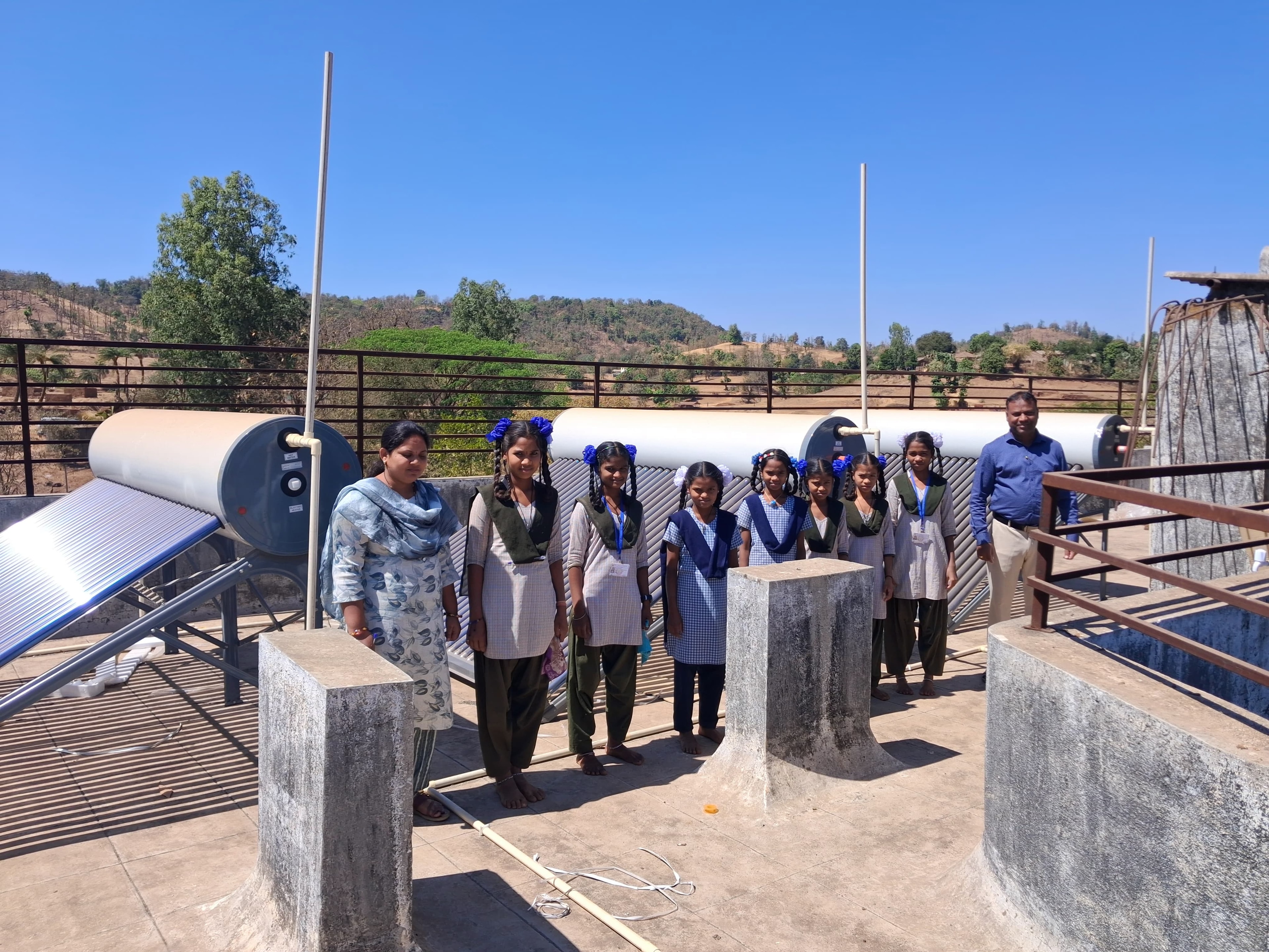 Students and teachers at solar water heating installation