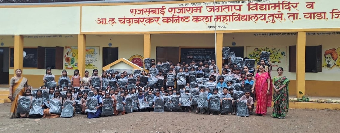 School group with teachers and students at bag distribution event
