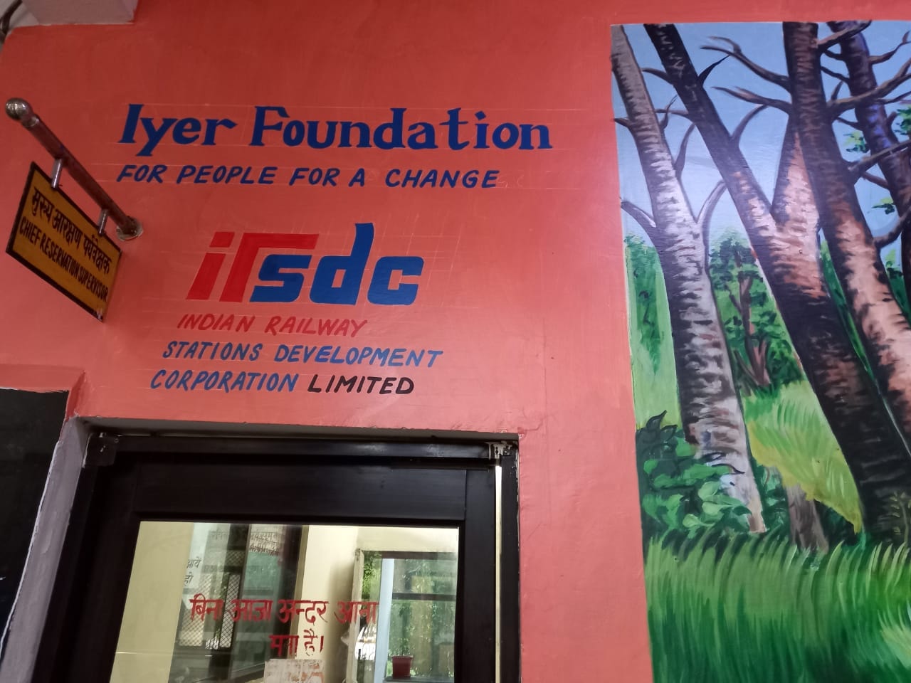 Iyer Foundation and IRSDC signage on a wall with mural
