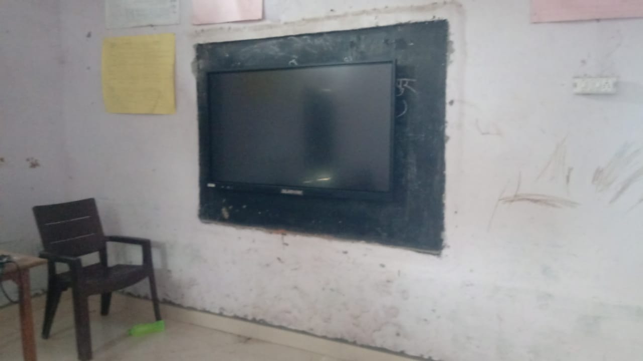 Smart board mounted on classroom wall — switched off, ready for the next lesson